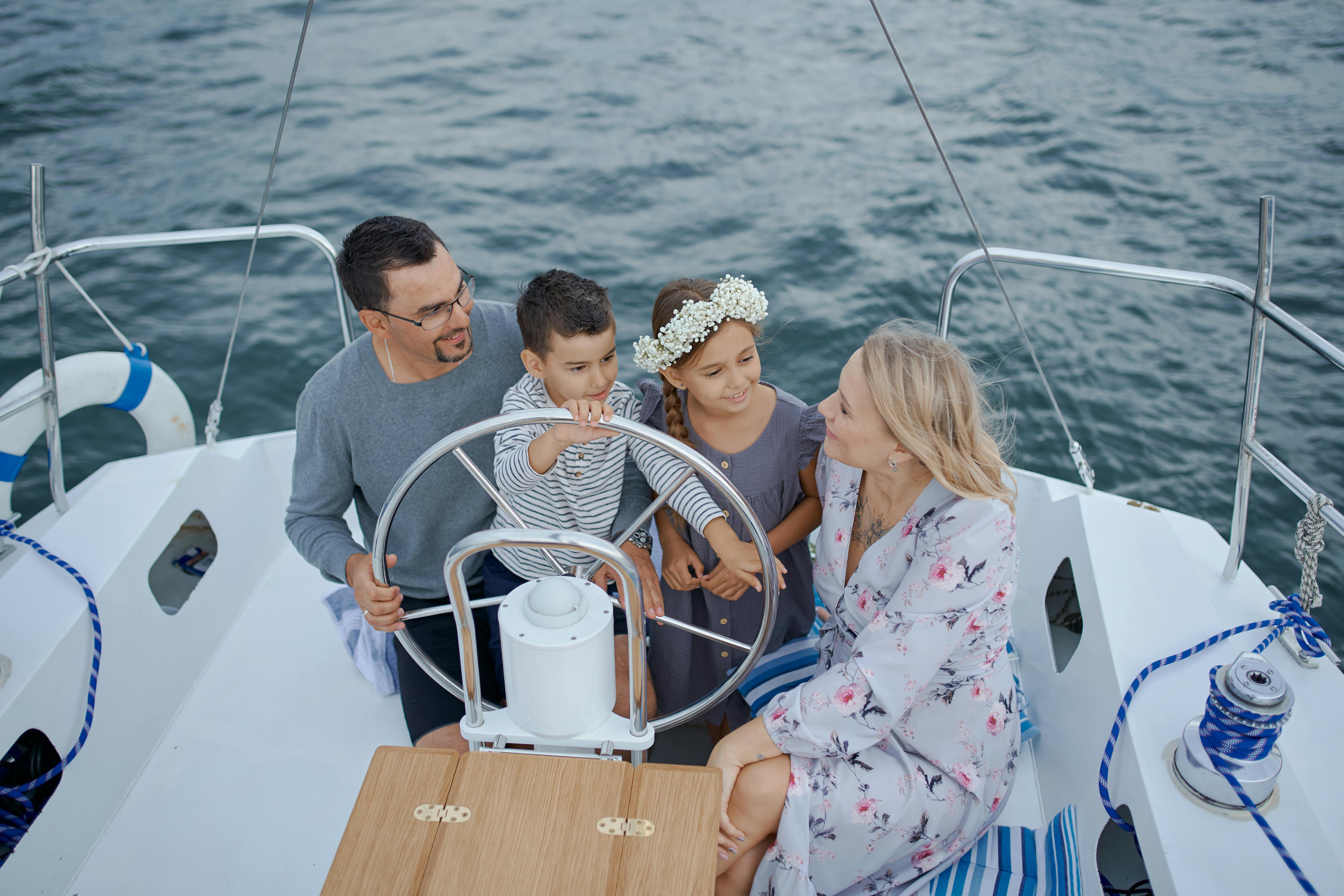 family with kids steering pontoon boat at lake of the ozarks