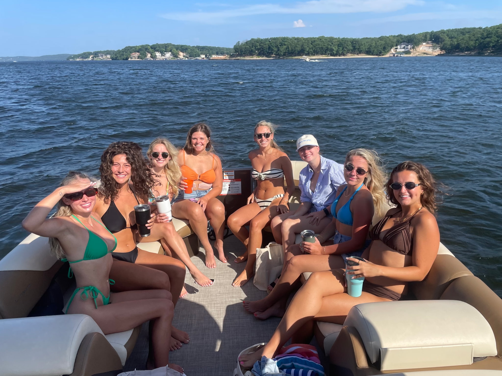 Sorority group enjoying a boat rental near Lake Ozark, Missouri, during a sunny Rush Week lake day.