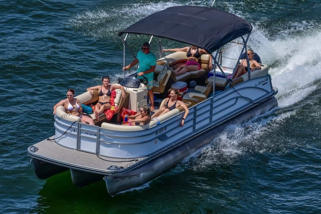 Group enjoying a tritoon boat rental on the water near Osage Beach, Missouri.