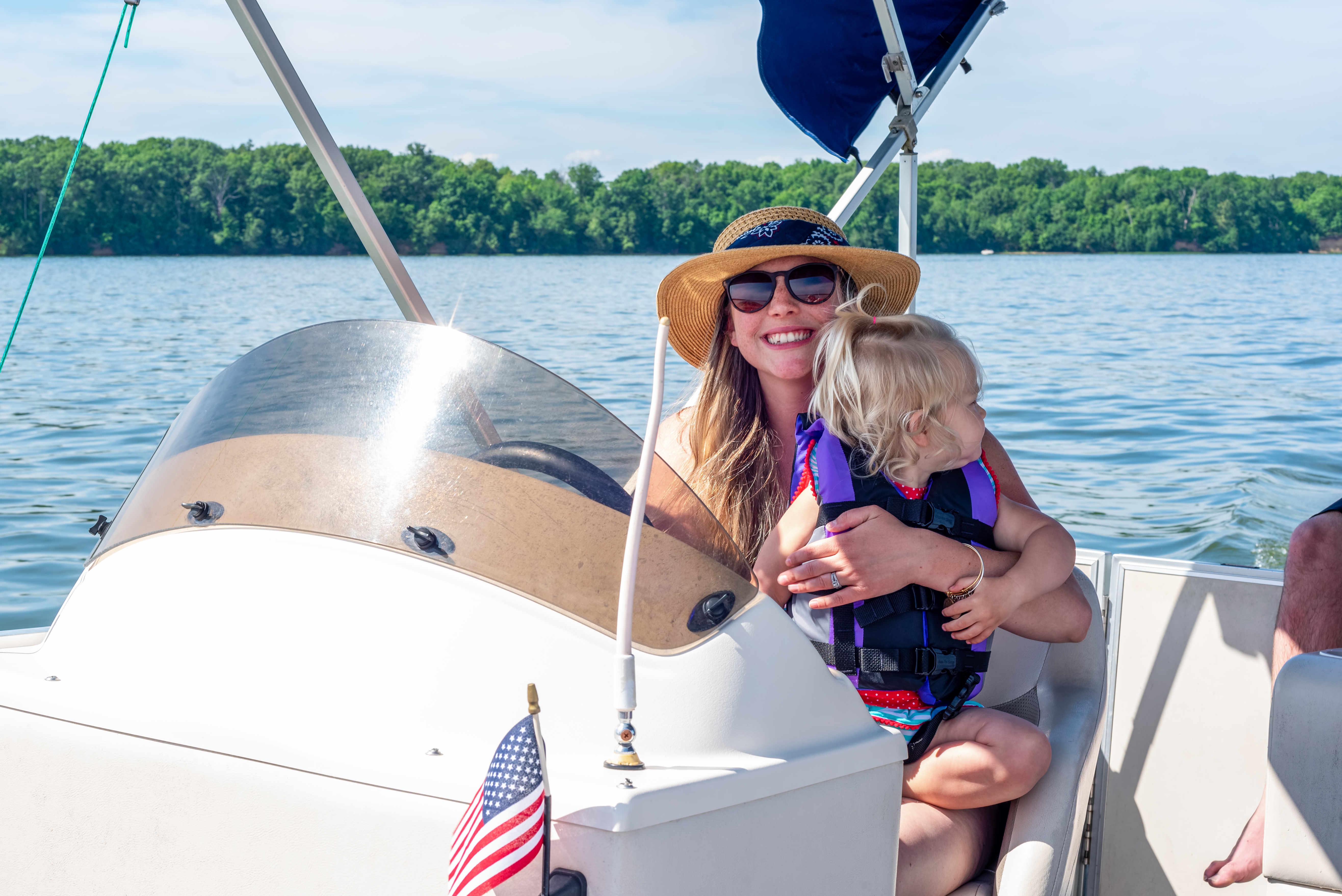 Woman and child enjoying a pontoon boat ride on Lake of the Ozarks